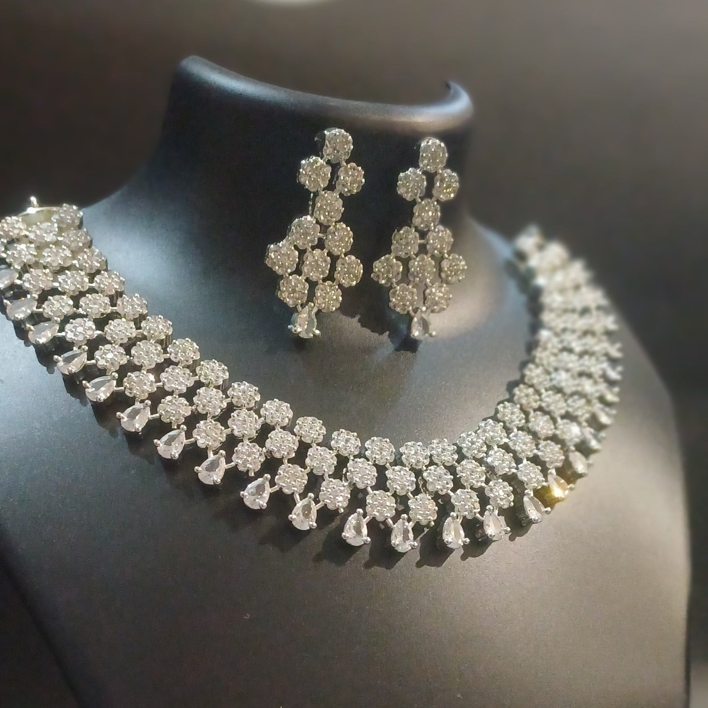 Diamond cluster silver hue band necklace with designer earrings