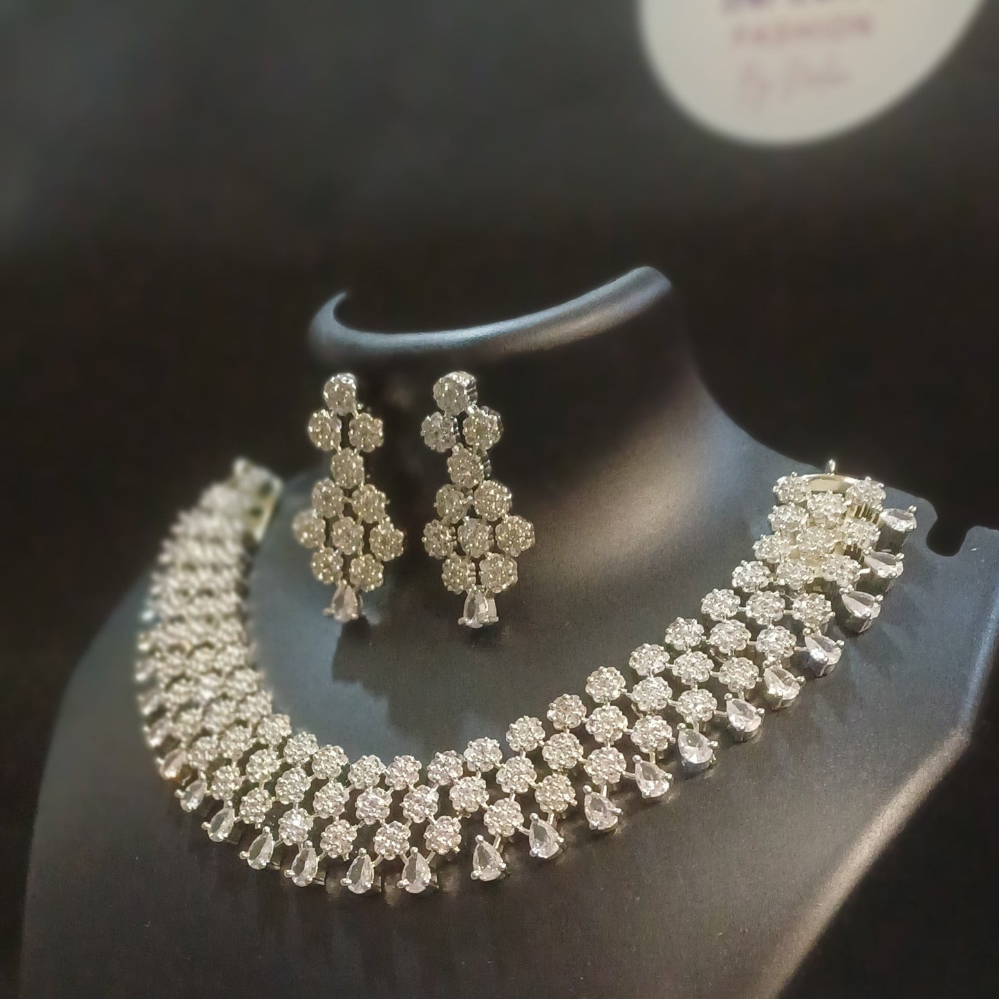 Diamond cluster silver hue band necklace with designer earrings