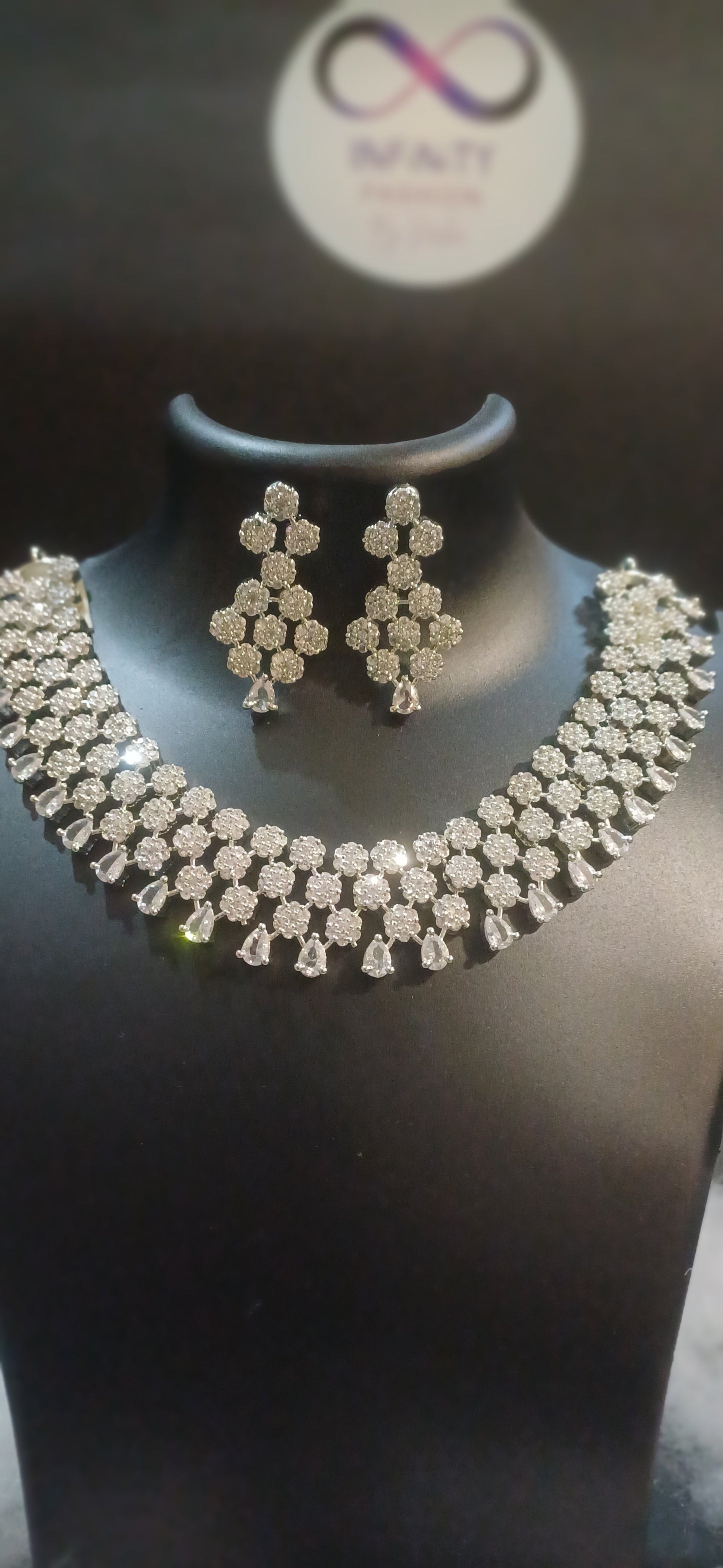 Diamond cluster silver hue band necklace with designer earrings