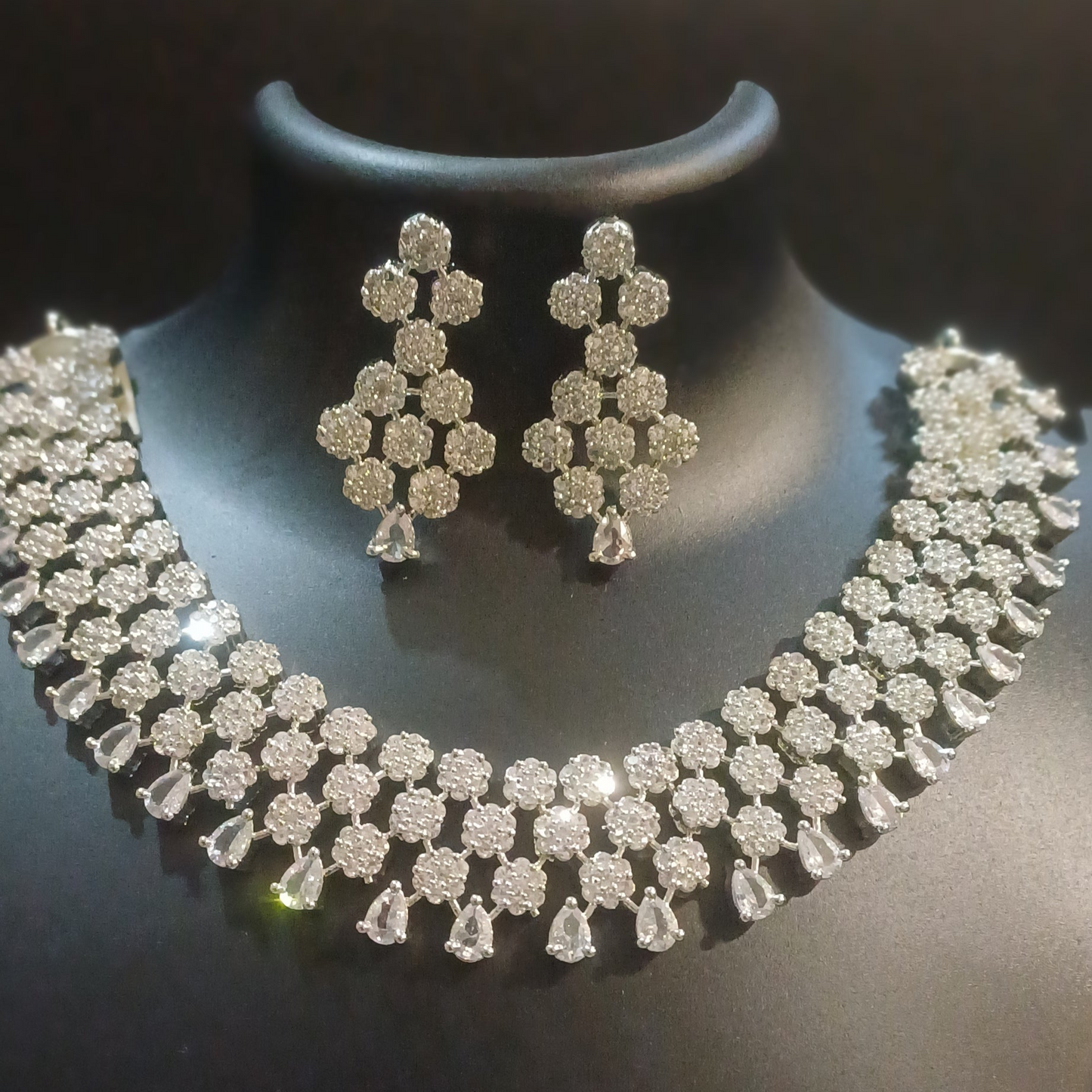 Diamond cluster silver hue band necklace with designer earrings
