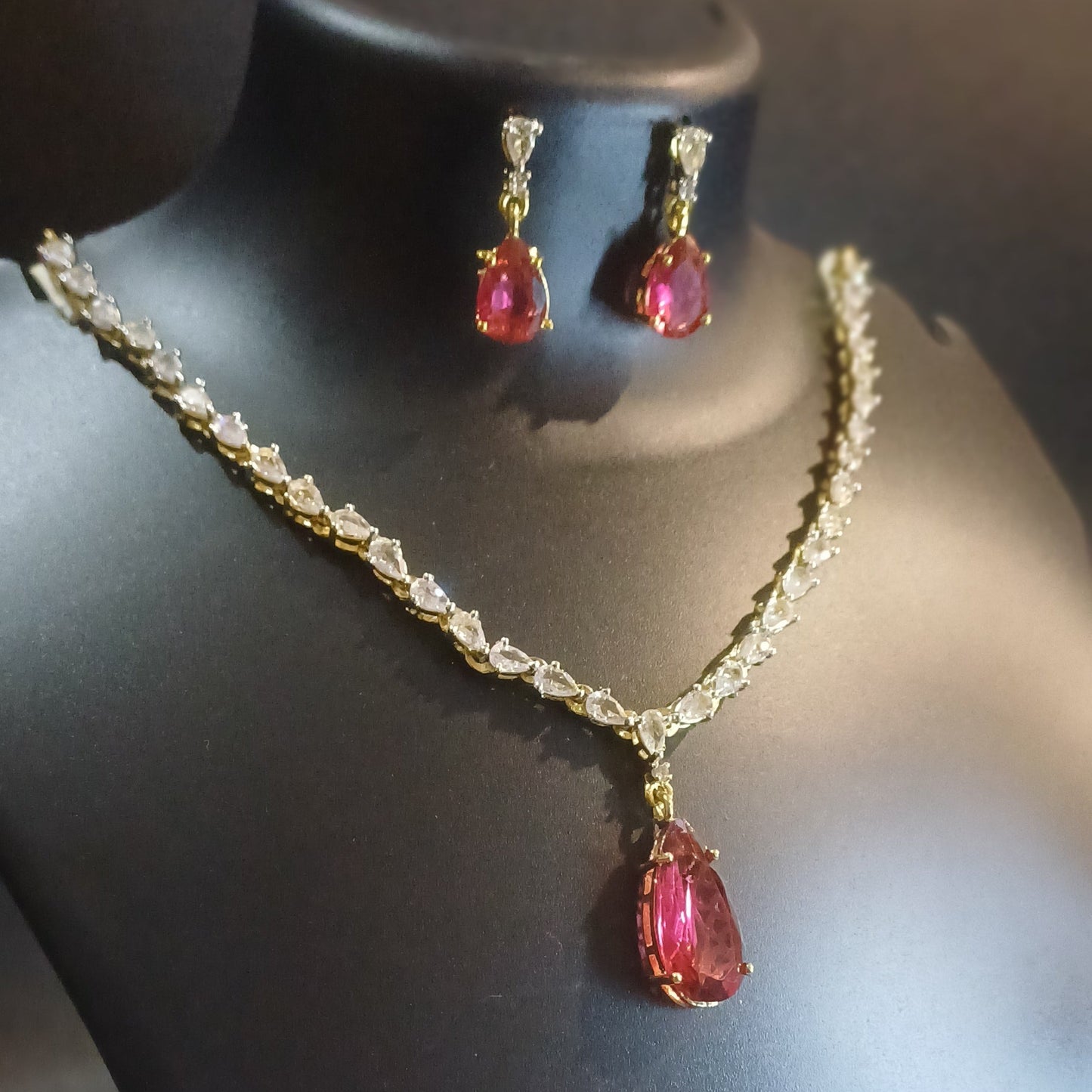 Red stoned Metallic golden single lined designer necklace with earrings