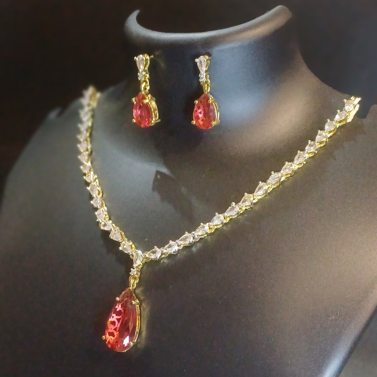 Red stoned Metallic golden single lined designer necklace with earrings
