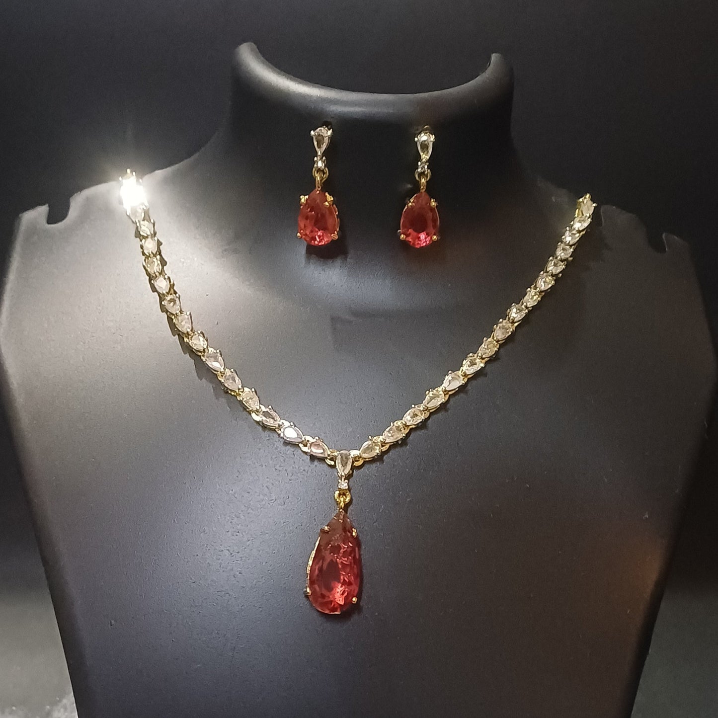Red stoned Metallic golden single lined designer necklace with earrings